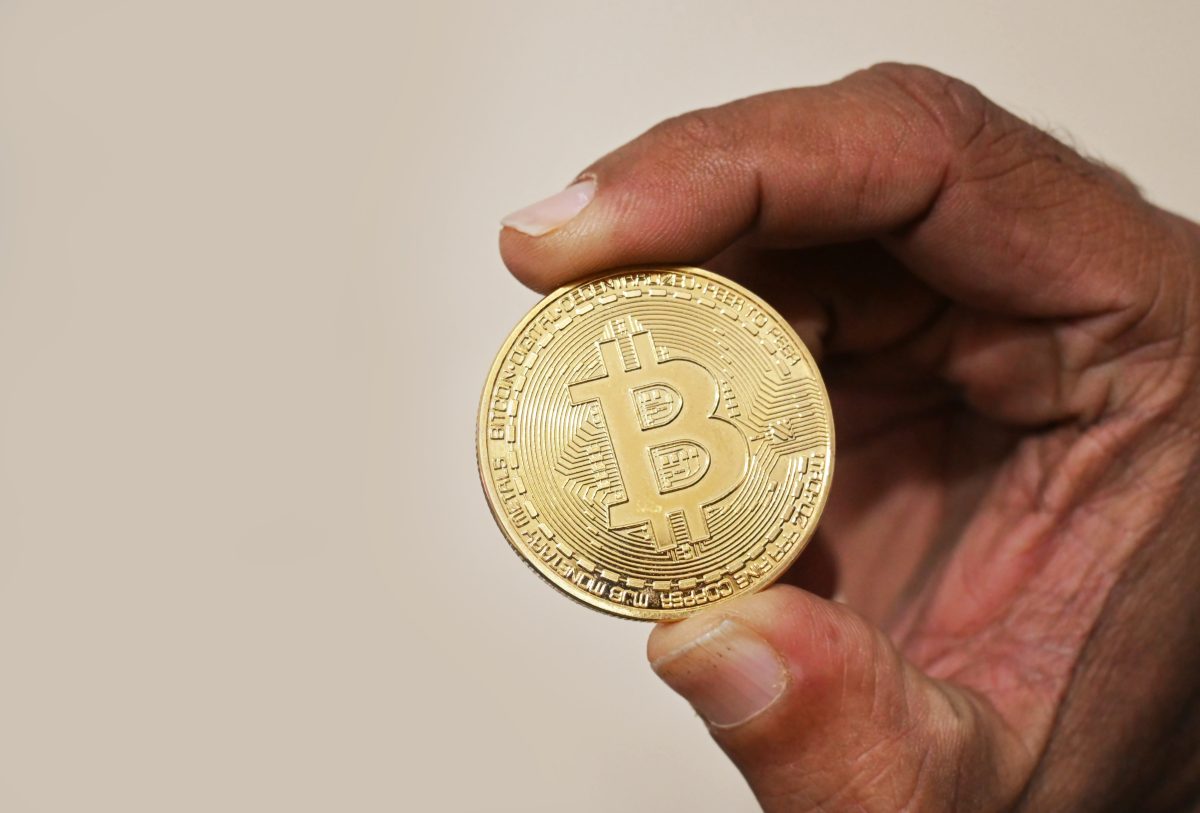 Hand holding a Bitcoin cryptocurrency coin