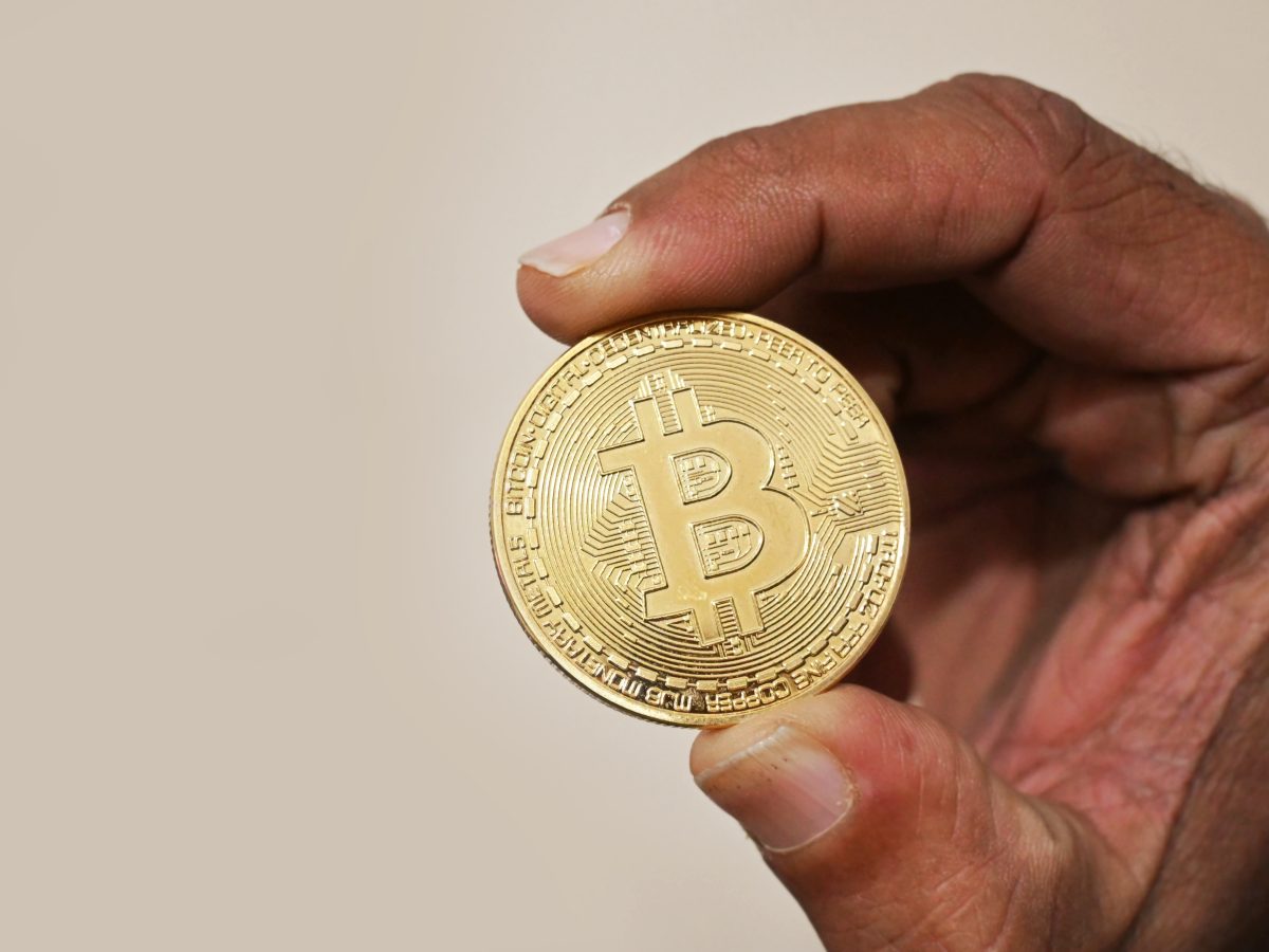 Hand holding a Bitcoin cryptocurrency coin