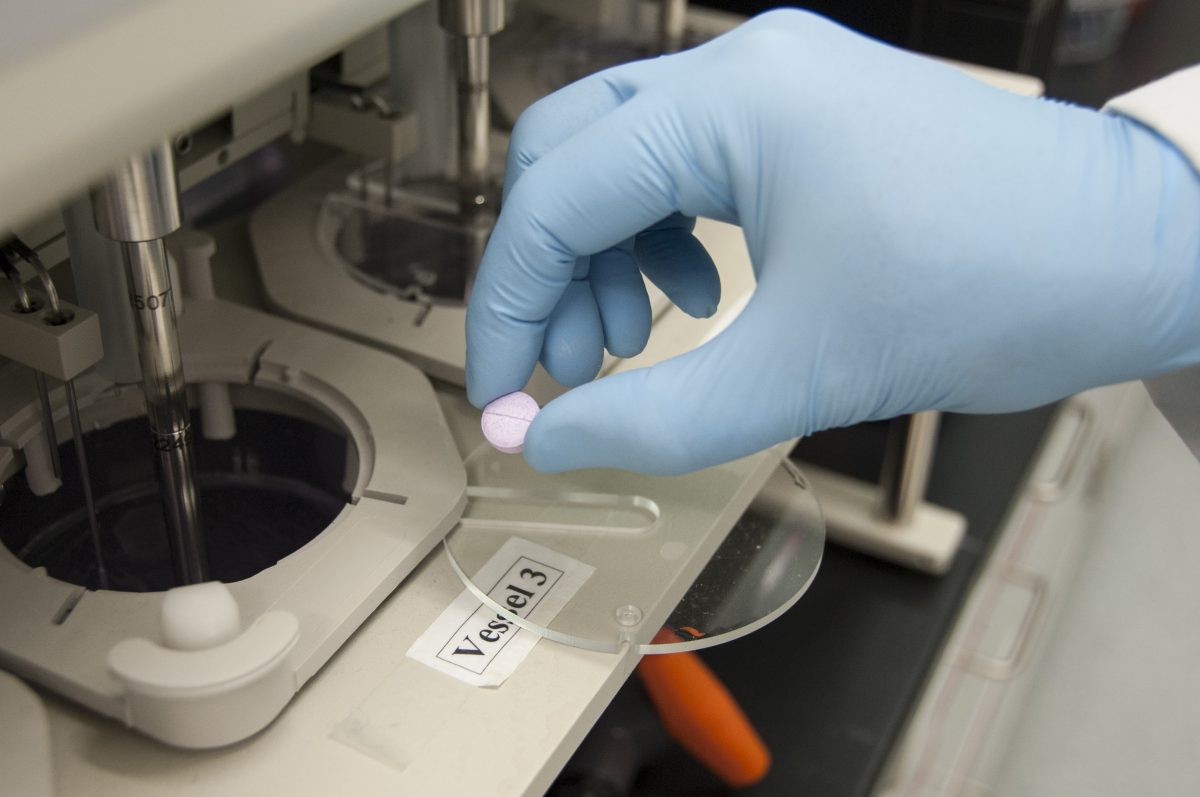 An FDA scientist tests how long a tablet takes to dissolve in pharmaceutical drug research