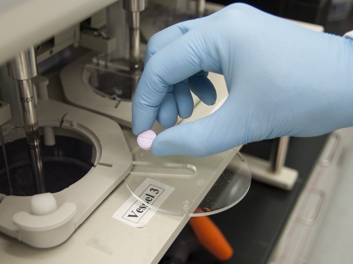 An FDA scientist tests how long a tablet takes to dissolve in pharmaceutical drug research