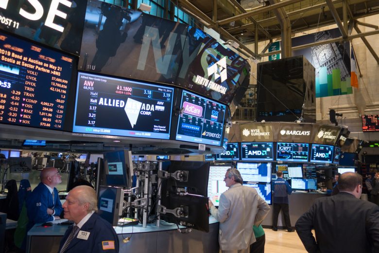 New York Stock Exchange trading floor with traders and screens
