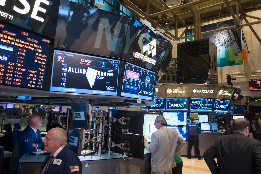 New York Stock Exchange trading floor with traders and screens