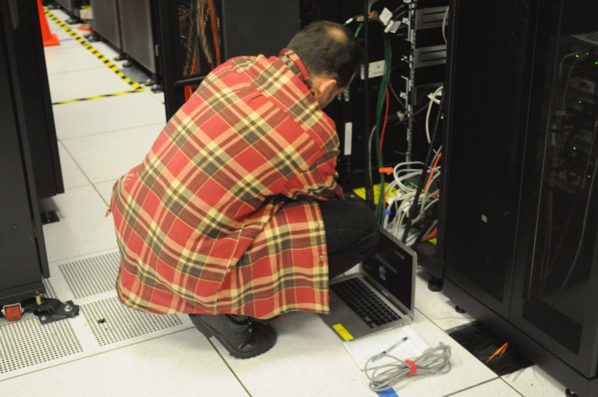 Technician working on server rack at NERSC data center