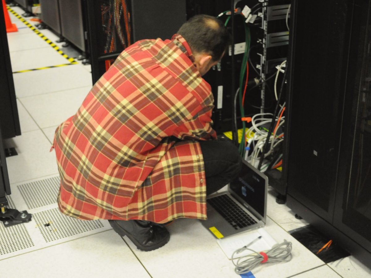 Technician working on server rack at NERSC data center