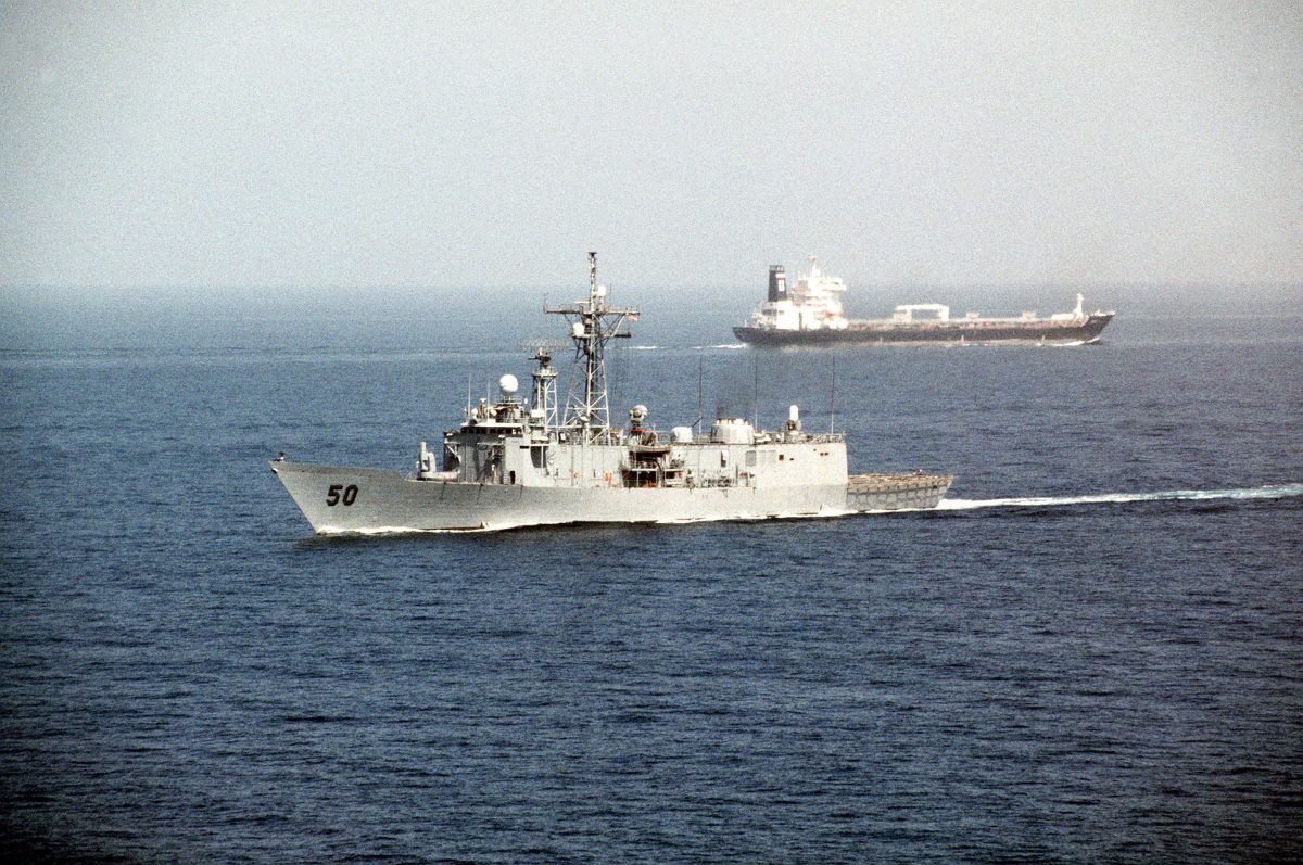 USS Taylor guided missile frigate passes a tanker in the Strait of Hormuz during Operation Desert Shield