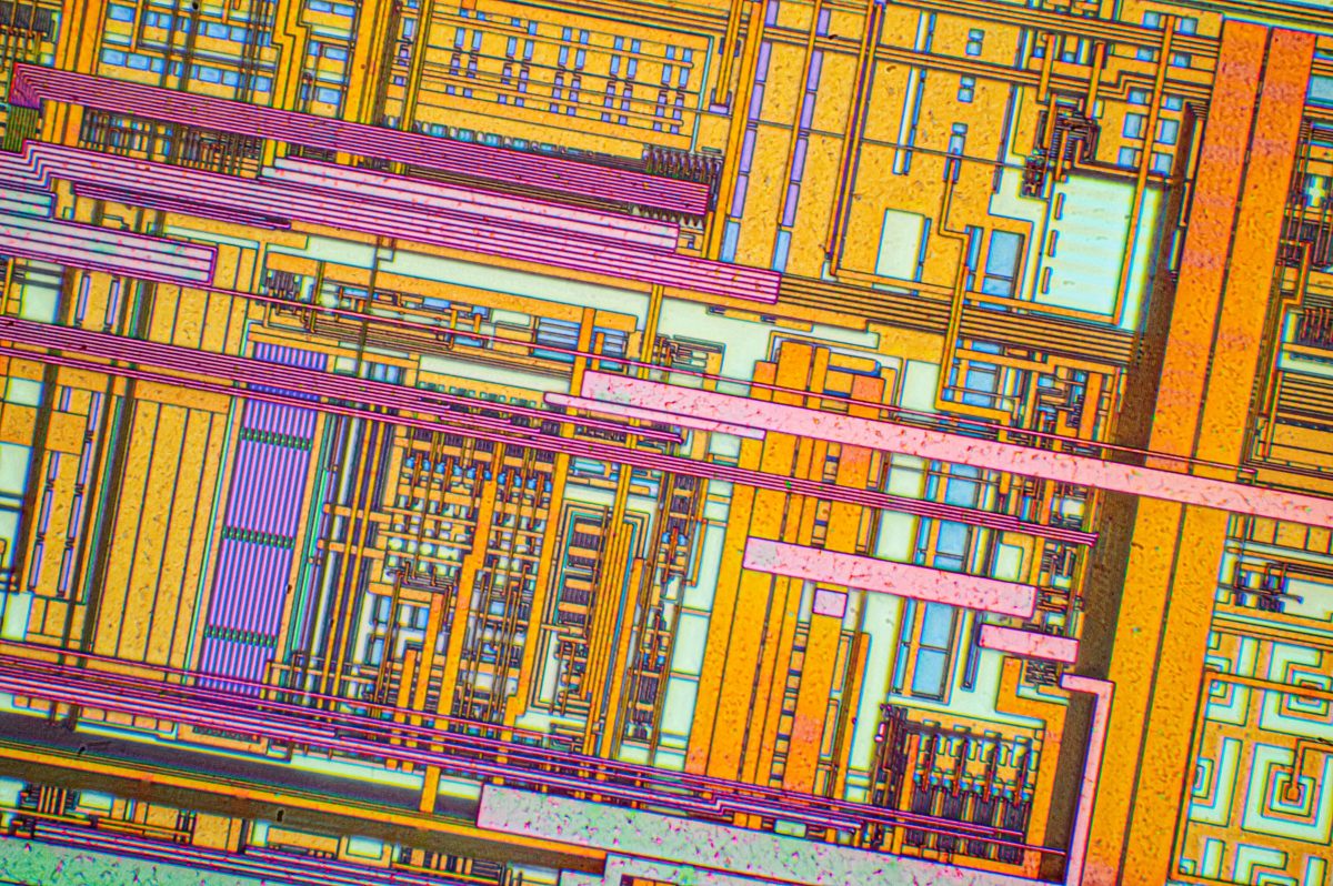 Silicon chip from a computer laser mouse under a microscope at 50x magnification
