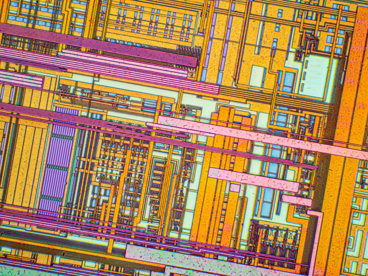 Silicon chip from a computer laser mouse under a microscope at 50x magnification