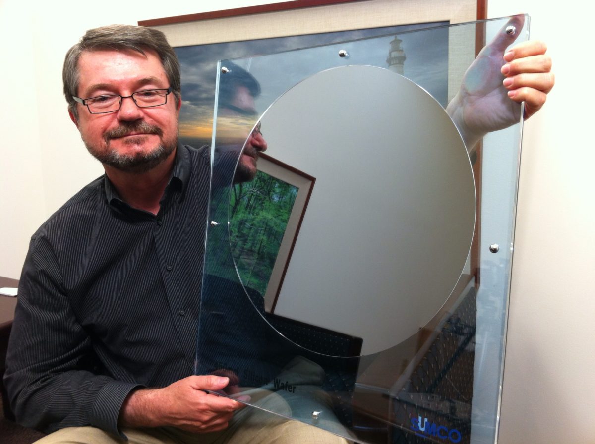 Dan Hutcheson of VLSI Research holds a 450mm silicon wafer, demonstrating semiconductor scale